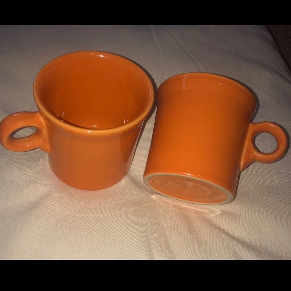 2 orange Fiesta mugs